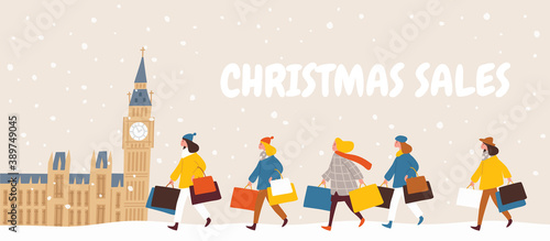 People, women, shopaholics with shopping bags after big mega christmas sales with houses of parliament and Big Ben in London on background.