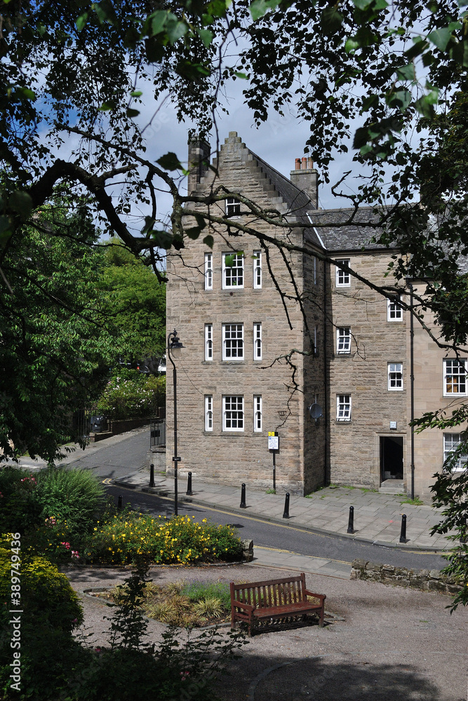 Fototapeta premium Exterior of Modern Scottish Stone Apartment Building & Bench 