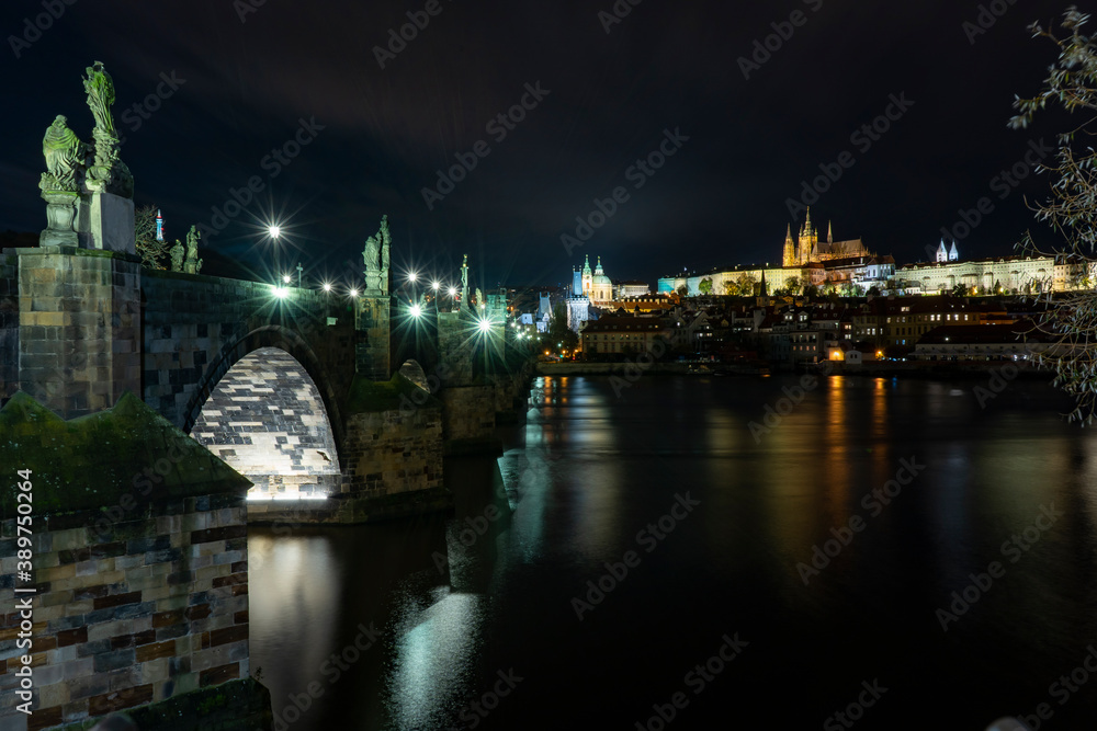 Fototapeta premium old stone Charles Bridge from the 14th century in the center of the old town of Prague at night in the Czech Republic