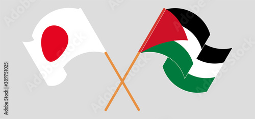 Crossed and waving flags of Palestine and Japan