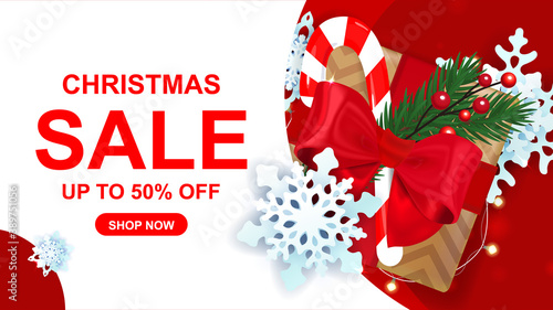 Christmas sale up to 50% off banner with gift box, snowflakes, garland.