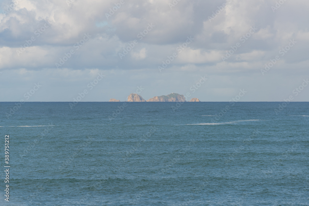 Berlengas island seen from Cabo Carvoeiro Cape in Peniche and atlantic ocean waves, in Portugal
