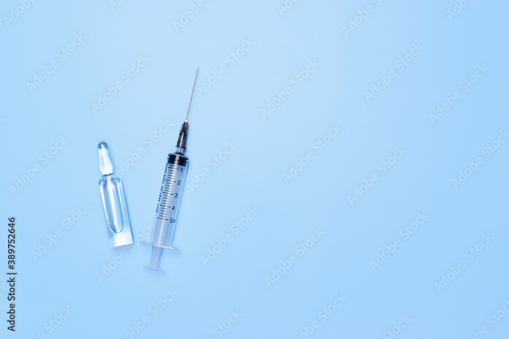 Syringe and ampoule with medicine. Water for injection in an ampoule. Medicine concept. Syringe and ampoule with medicine. Water for injection in an ampoule. Medicine concept.