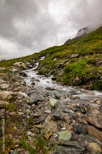 Mountain stream in the Switzerland. net blue water in Swiss Alps