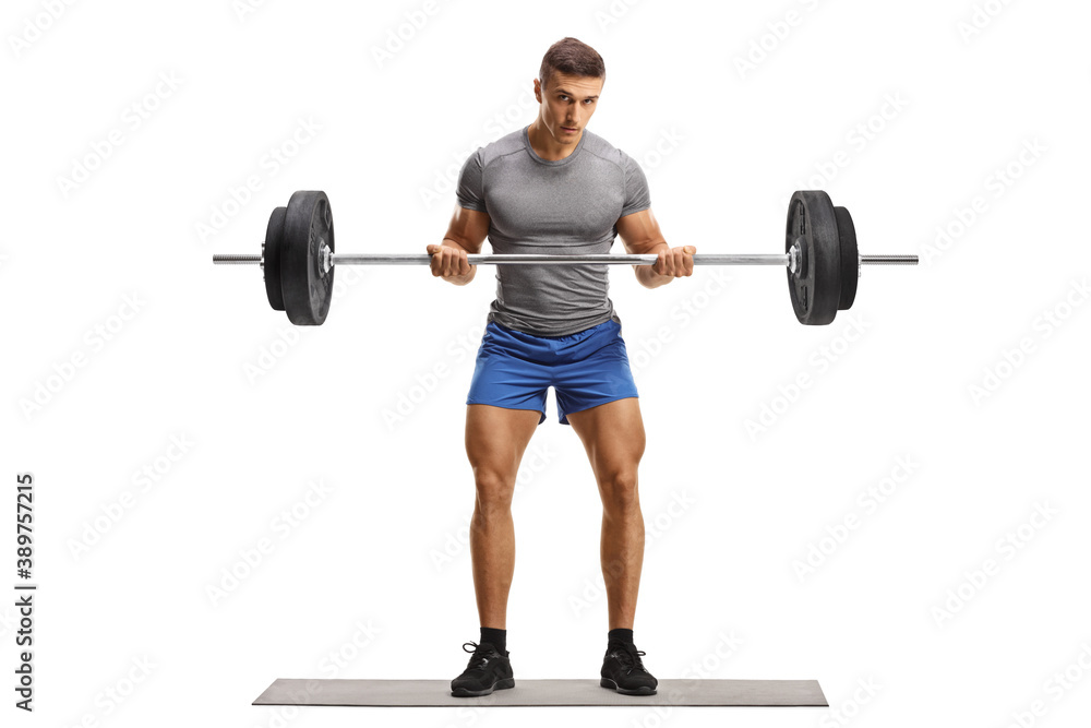 Full length portrait of a strong young man in sportswear lifting heavy weight Full length portrait of a strong young man in sportswear lifting heavy weight
