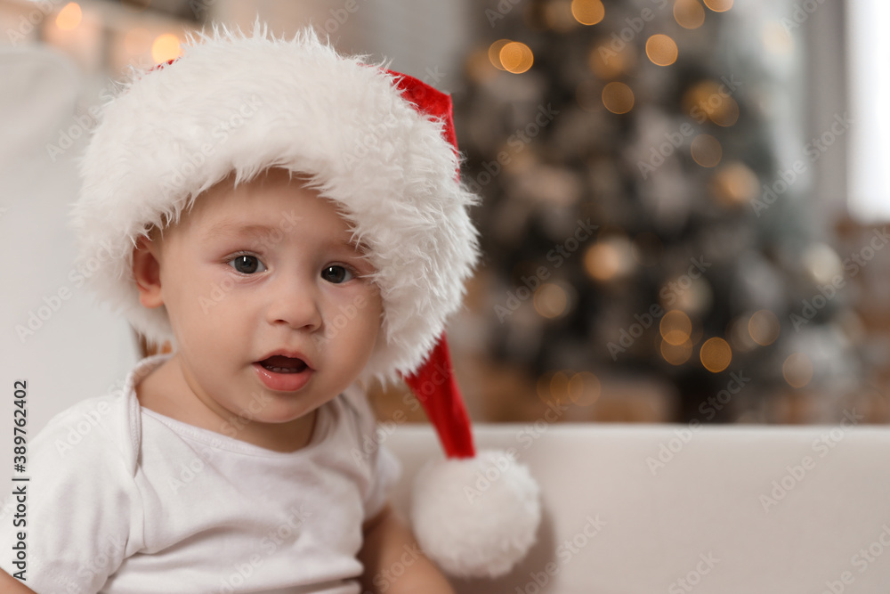 Cute little baby wearing Santa hat at home. Christmas celebration Cute little baby wearing Santa hat at home. Christmas celebration
