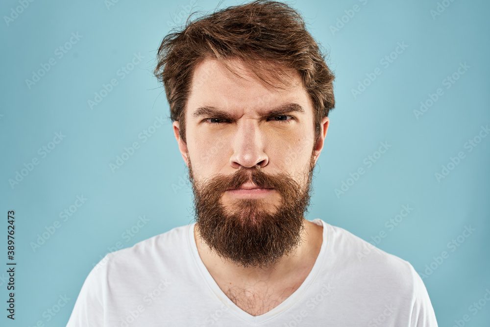 Obraz premium Bearded man emotions facial expression gestures hands close-up blue background