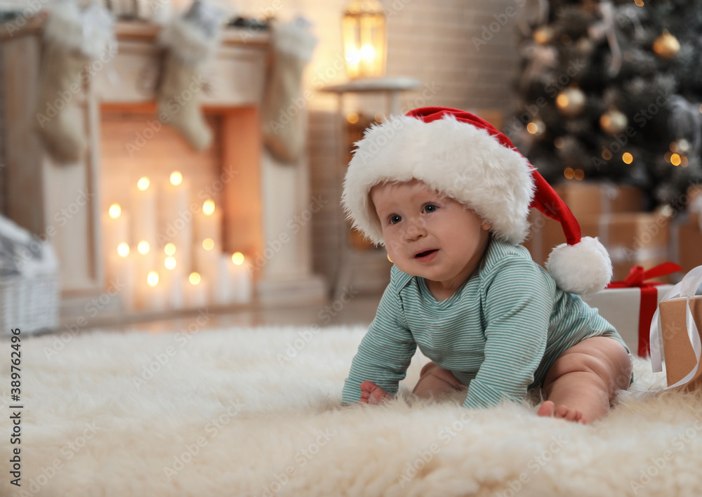 Cute baby in Santa hat crawling on floor. First Christmas Cute baby in Santa hat crawling on floor. First Christmas