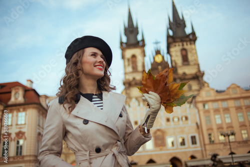 Photography smiling stylish woman in beige trench coat and black beret