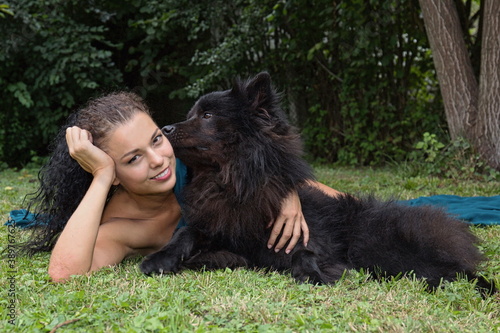 Beautiful young woman with black dog.