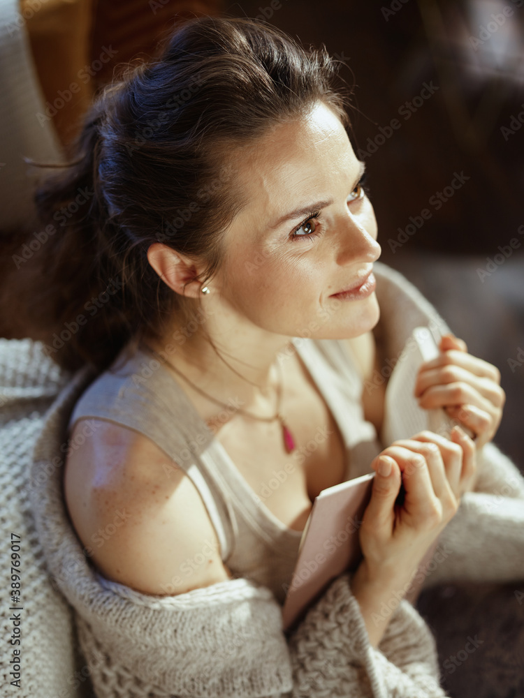 relaxed young woman in modern house in sunny winter day