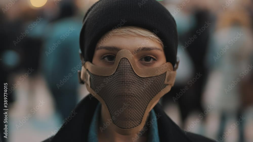 Portrait of young woman with face mask in the crowd. High quality 4k footage Portrait of young woman with face mask in the crowd. High quality 4k footage