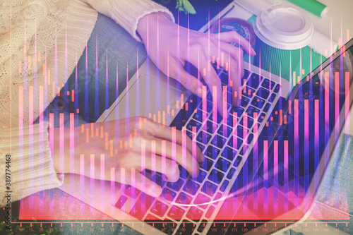 Double exposure of woman hands typing on computer and forex chart hologram drawing. Stock market invest concept.