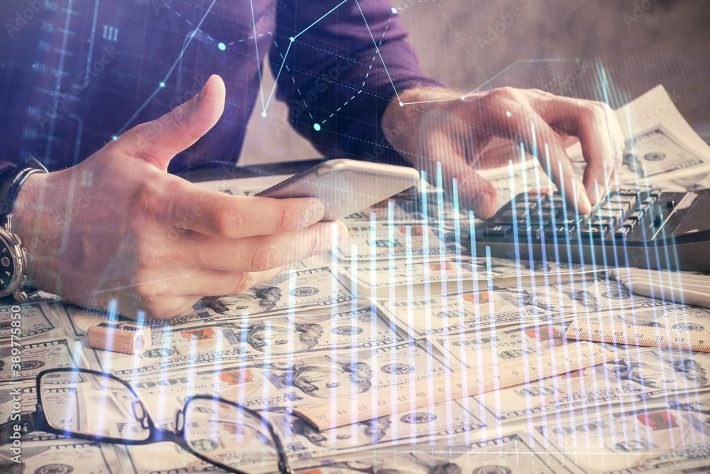 Double exposure of man's hands holding and using a digital device and forex graph drawing. Financial market concept. Double exposure of man's hands holding and using a digital device and forex graph drawing. Financial market concept.