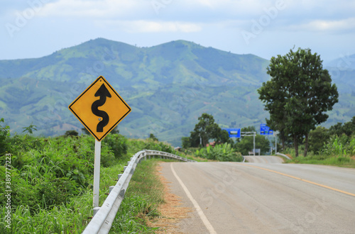 sharp curve sign with view of mountain in Thailand 