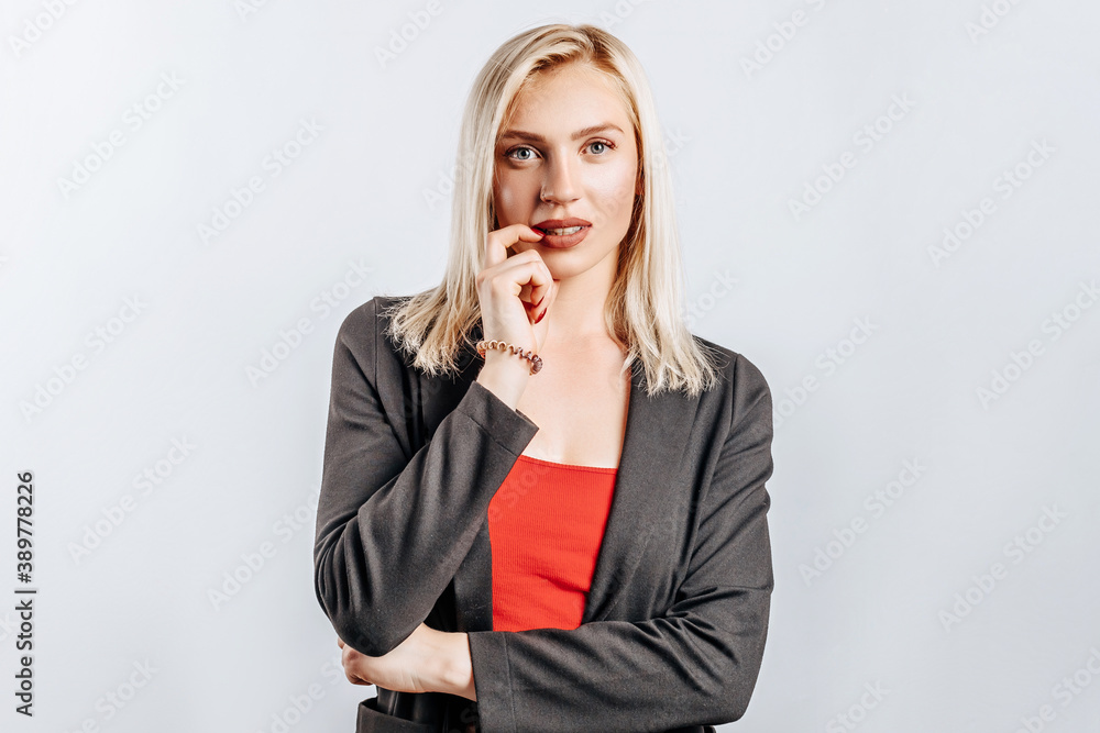 Beautiful young girl unhappy and thinks on gray isolated background Beautiful young girl unhappy and thinks on gray isolated background