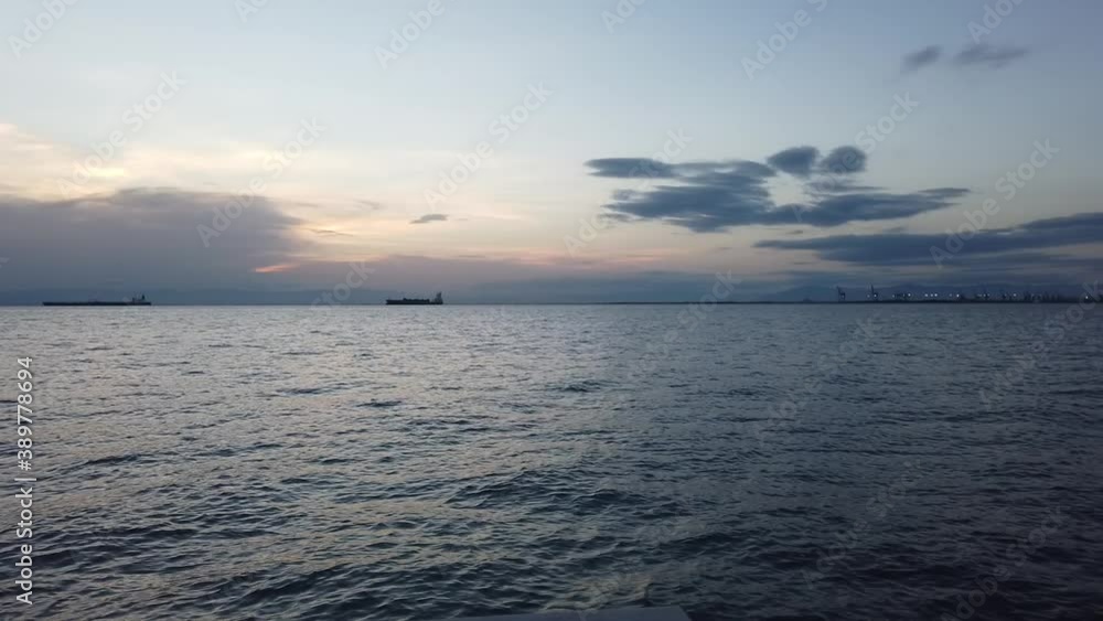 Clip of the sea and cargo ships on the port of Thessaloniki in Greece during sunset Clip of the sea and cargo ships on the port of Thessaloniki in Greece during sunset