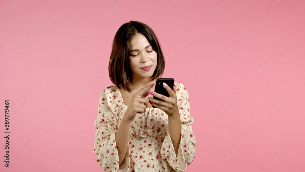 Attractive brunette woman with mobile phone. Girl using smartphone, surfing internet, chatting in social networks. Technology concept. Attractive brunette woman with mobile phone. Girl using smartphone, surfing internet, chatting in social networks. Technology concept.