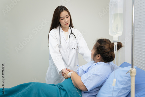 Asian woman doctor visiting a patient who has a critical health problem about her weight and unhealthy eating 