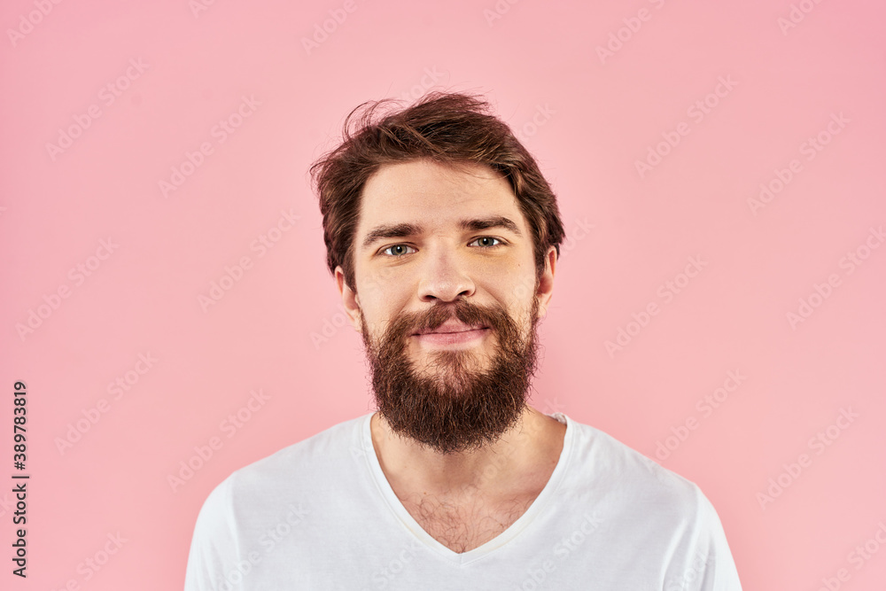 Fototapeta premium Man in white t-shirt gestures with hands emotions lifestyle cropped view pink background