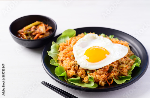 Korean food, Kimchi fried rice with fried egg on top and fresh kimchi cabbage