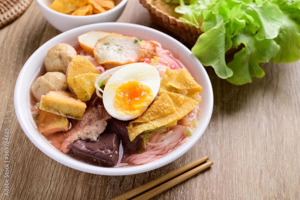 Thai food (Yen Ta Fo), Rice noodles soup with red sauce and fish tofu, pork ball and fried wonton in a bowl