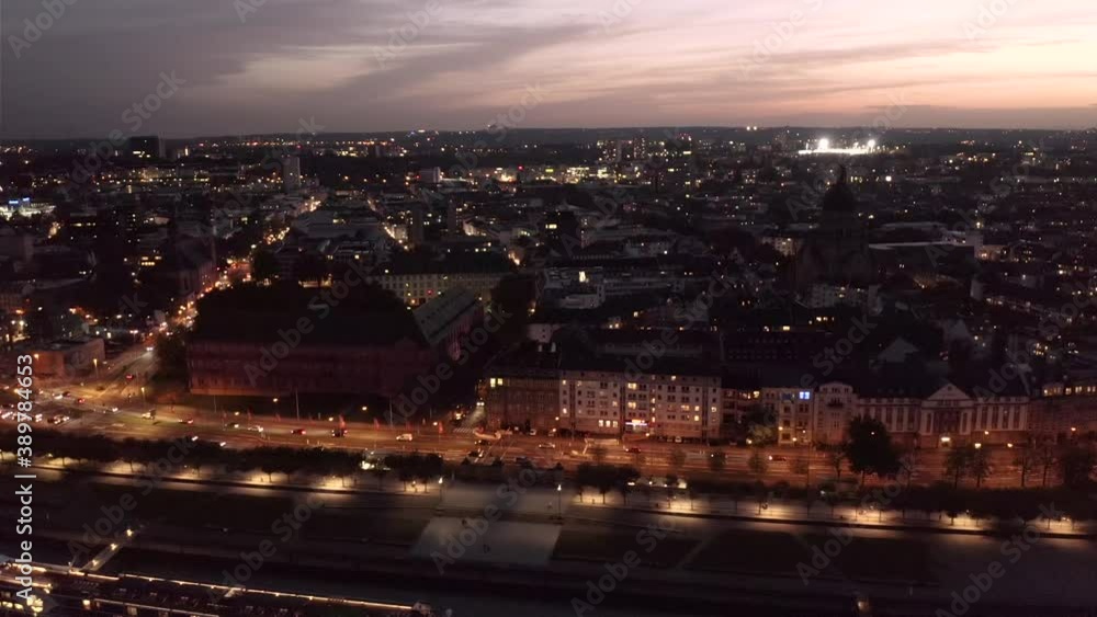 Neustadt part of Mainz in the evening after sunset with glow on the sky by a drone showing a Rhine river ship on the dark water Neustadt part of Mainz in the evening after sunset with glow on the sky by a drone showing a Rhine river ship on the dark water