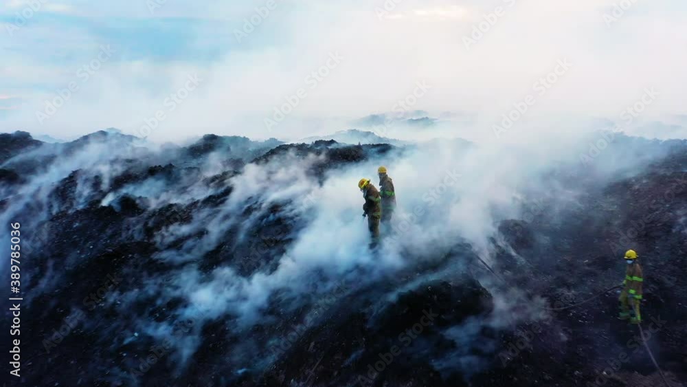 Aerial view of firefighters extinguishing a smoking wildfire, deforestation a raging forest fire, in Pantanal, Brazil, South America - pull back, drone shot Aerial view of firefighters extinguishing a smoking wildfire, deforestation a raging forest fire, in Pantanal, Brazil, South America - pull back, drone shot