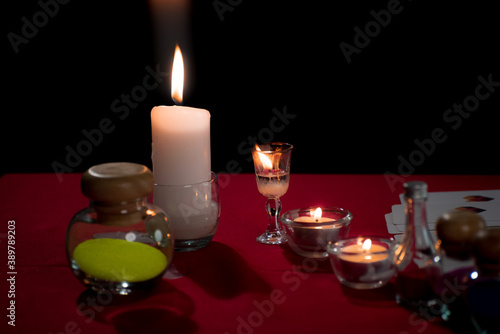 Close up Gypsy fortune teller in dark room with white tarot card and candle light