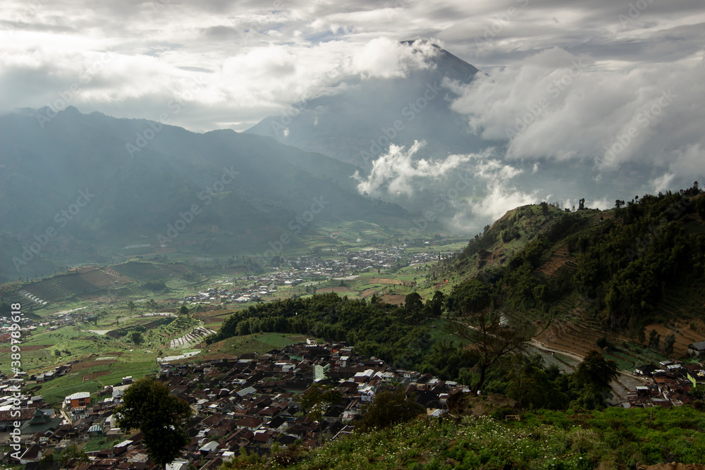 tourist destinations in the Dieng Plateau, Central Java. see rural scenery at the foot of the Sikunung mountains and Mount Sindoro and the hills decorated with a thin fog