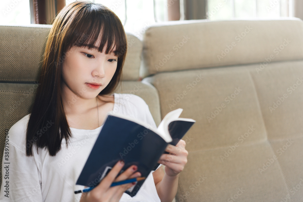 Asian teenager woman reading a book for learn and study at home. Asian teenager woman reading a book for learn and study at home.