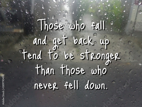 Inspirational motivational quote - Those who fall and get back up tend to be stronger than those who never fell down. Words of wisdom on background of rain drops on the window. Never give up concept.