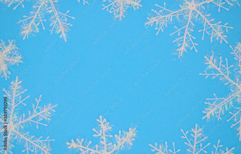 White snowflakes on a blue background. Christmas background. Christmas flat lay.