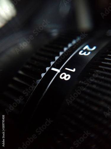 Extreme close up shot of camera lens focal distance numbers dial.