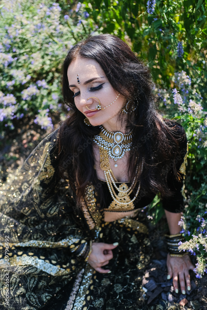 Woman in ethnic indian costume with gold jewellery and traditional makeup. Woman in ethnic indian costume with gold jewellery and traditional makeup.