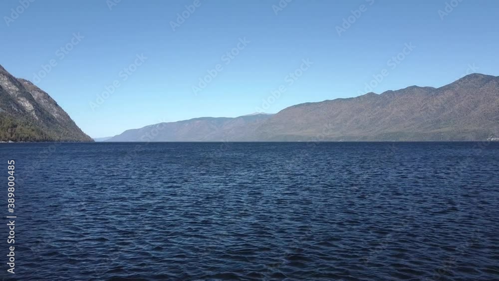 Beautiful view over the mountain lake. Flying over water top view. Teletskoye lake, Altai. High quality FullHD footage Beautiful view over the mountain lake. Flying over water top view. Teletskoye lake, Altai. High quality FullHD footage