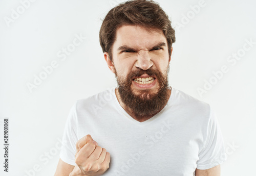 Man in t-shirt gesturing emotions irritability with his hands