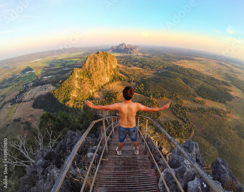 Shirtless guy hiking in the top of the mountain with awesome view