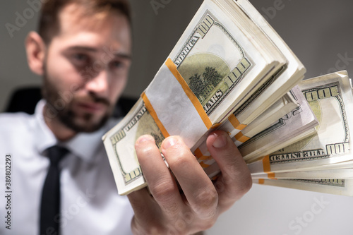A man with bundles of dolla...