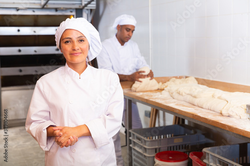 Portrait of a baker chef in a small bakery. High quality photo