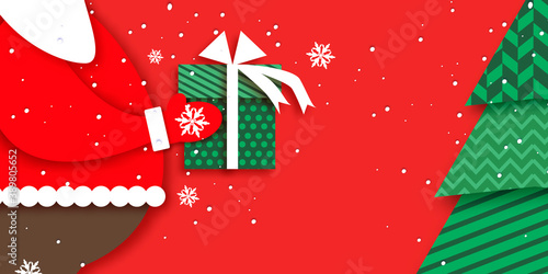 Merry Christmas Greetings Card with Santa Claus hands holding green giftbox with white bow. Magic Cristmas tree. Happy New Year in papercraft style. Red background. Winter holidays.