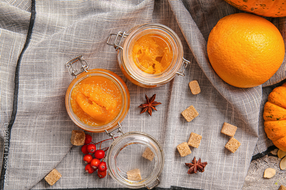 Jars of tasty pumpkin jam on table Jars of tasty pumpkin jam on table