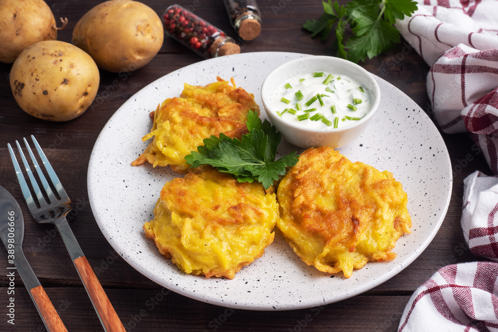 Fried cakes of grated potatoes on the plate with sauce. Traditional pancakes boxty raggmunk. Fried cakes of grated potatoes on the plate with sauce. Traditional pancakes boxty raggmunk.