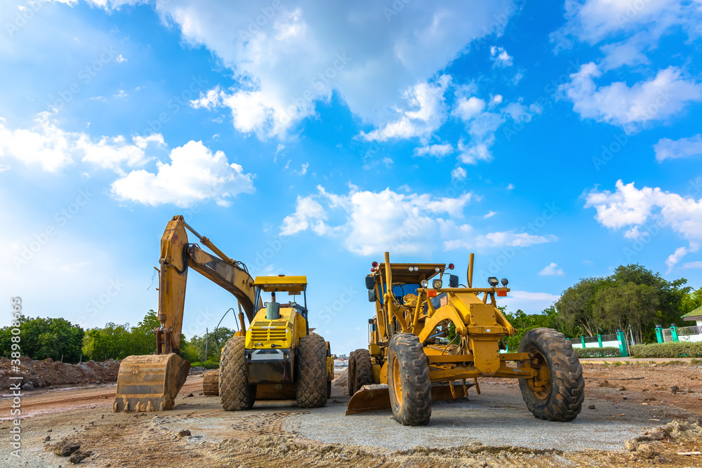 Backhoe, grader and road roller on the ground at site construction. Backhoe, grader and road roller on the ground at site construction.