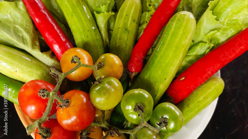 Colorful organic vegetables sourced from closed farms are healthy food. On a black background