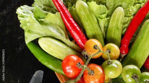 Colorful organic vegetables sourced from closed farms are healthy food. On a saucer and black as a background