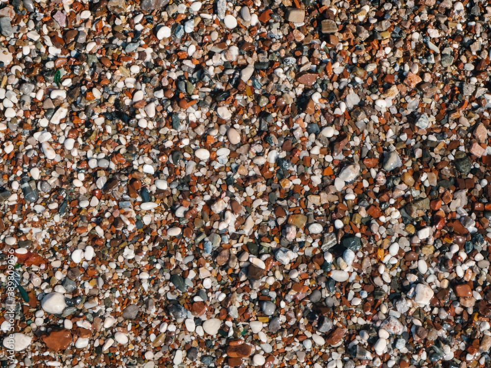 Wet sea pebbles or rocks, stones as nature background. Beautiful sea stones of different sizes, colors and texture. Excellent natural concept for interior exterior decoration or any design. Wet sea pebbles or rocks, stones as nature background. Beautiful sea stones of different sizes, colors and texture. Excellent natural concept for interior exterior decoration or any design.