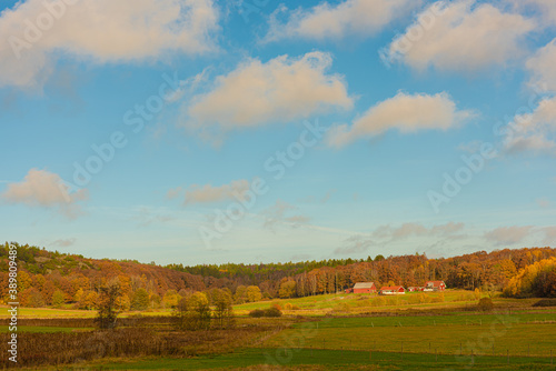 Autumn landscape with fields and a farm.