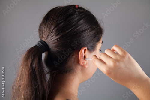 Women clean the ear with cotton swab.