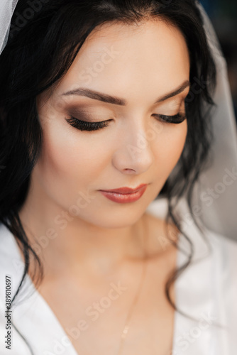 portrait of a Caucasian girl bride brunette with makeup and styling